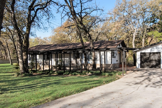 view of front facade with a front lawn, covered porch, an outdoor structure, and a garage