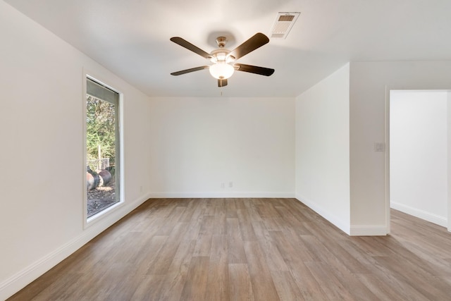 spare room with light hardwood / wood-style floors and ceiling fan