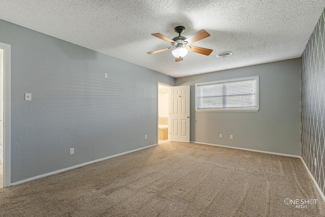 carpeted empty room with a textured ceiling and ceiling fan