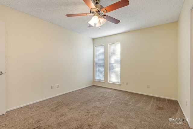 spare room featuring carpet flooring, ceiling fan, and a textured ceiling