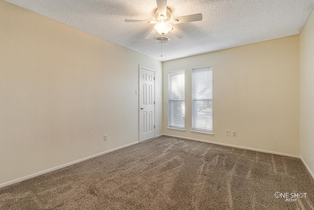 carpeted spare room with a textured ceiling and ceiling fan