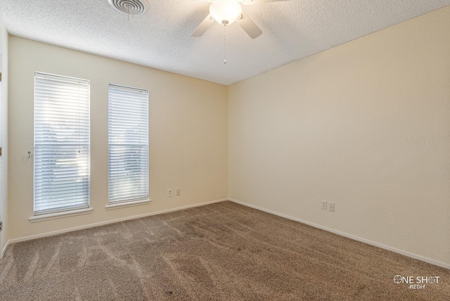 empty room featuring carpet flooring and a textured ceiling