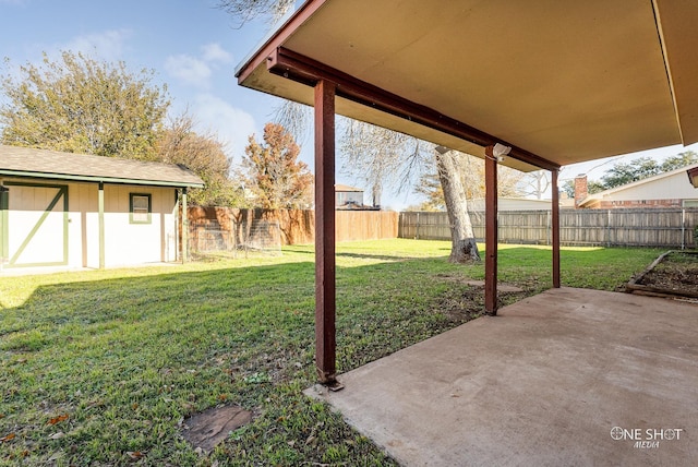 view of yard featuring a storage unit and a patio area