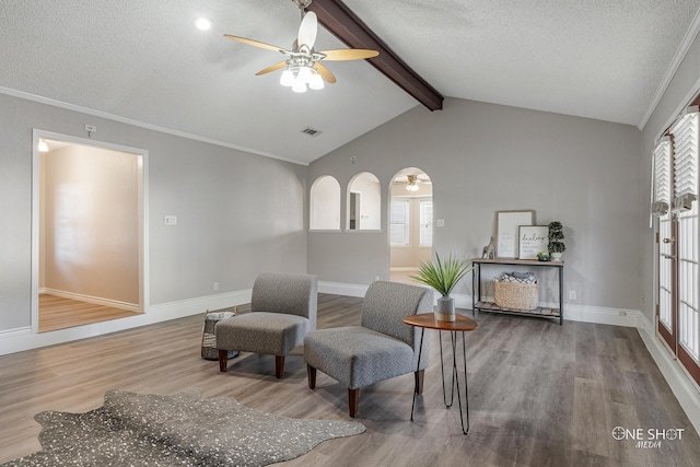 sitting room featuring ceiling fan, lofted ceiling with beams, a textured ceiling, and hardwood / wood-style flooring