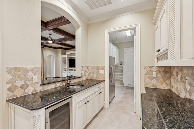 kitchen featuring coffered ceiling, white cabinets, beam ceiling, stainless steel fridge with ice dispenser, and beverage cooler