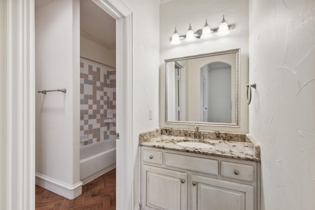 bathroom featuring vanity, shower / bathtub combination, and parquet flooring