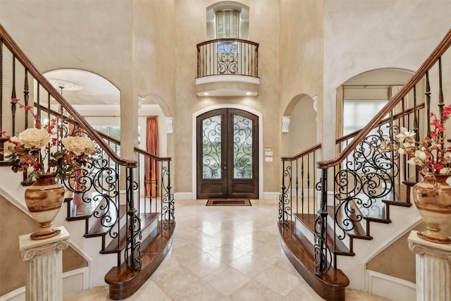 foyer entrance with french doors and a high ceiling