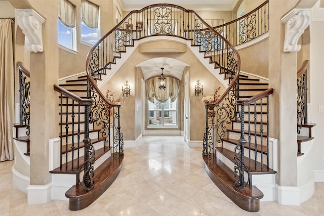 entryway with a towering ceiling and an inviting chandelier