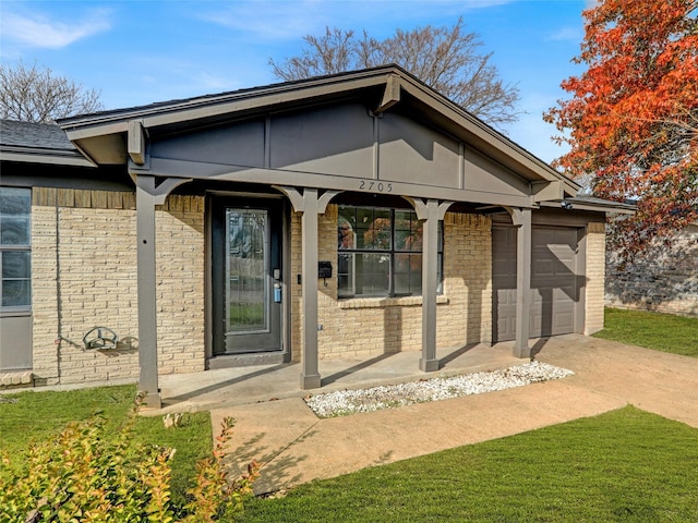 exterior space with a lawn, a porch, and a garage