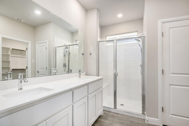 bathroom with vanity, hardwood / wood-style flooring, and an enclosed shower