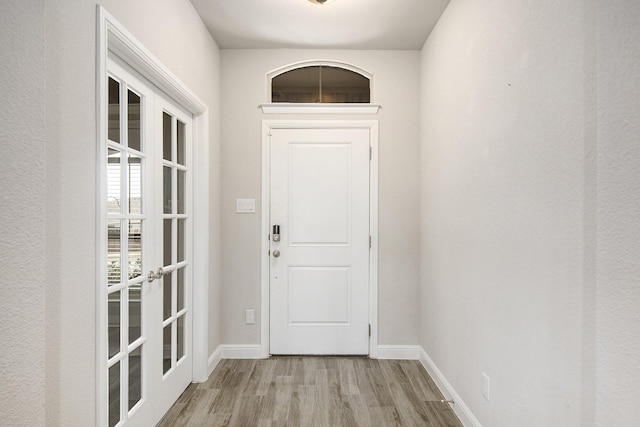 entryway with french doors and light wood-type flooring