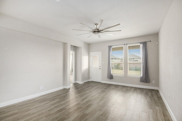 spare room with hardwood / wood-style floors and ceiling fan