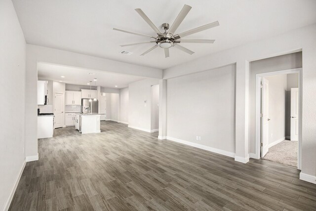 spare room featuring ceiling fan and dark hardwood / wood-style flooring