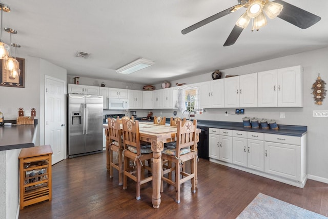 kitchen featuring dark wood-type flooring, white cabinets, stainless steel refrigerator with ice dispenser, black dishwasher, and decorative light fixtures