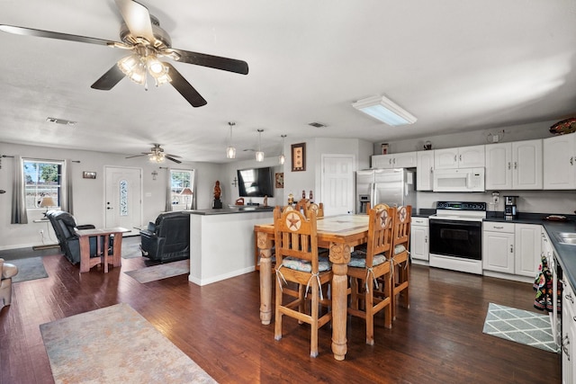 dining room featuring ceiling fan and dark hardwood / wood-style floors