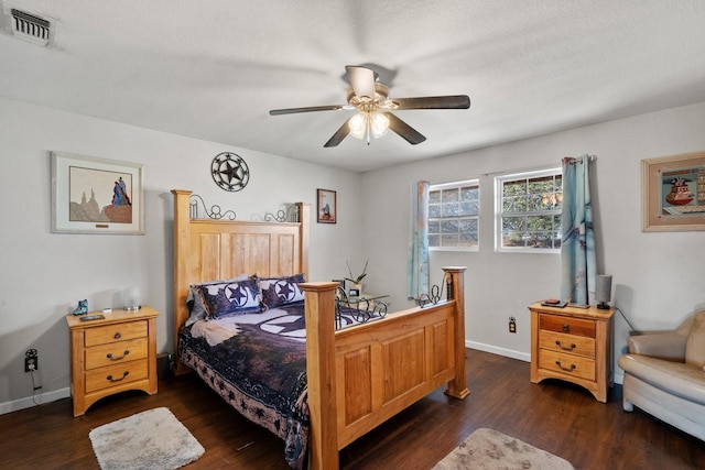 bedroom featuring a textured ceiling, ceiling fan, and dark hardwood / wood-style floors