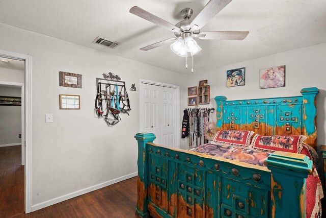 bedroom with dark hardwood / wood-style floors and ceiling fan