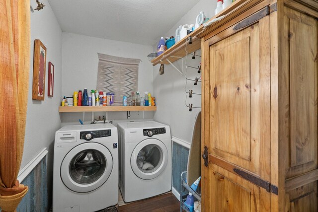 laundry room with washer and clothes dryer and dark hardwood / wood-style floors