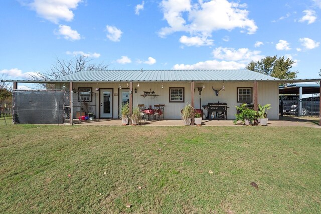 back of property featuring a yard