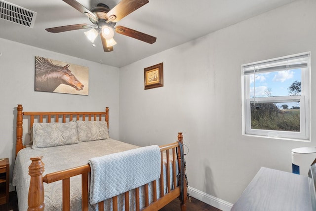 bedroom with ceiling fan and dark wood-type flooring