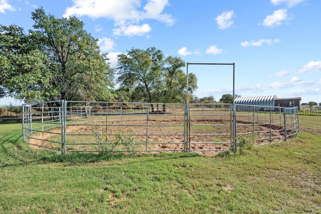 view of yard with a rural view and an outdoor structure