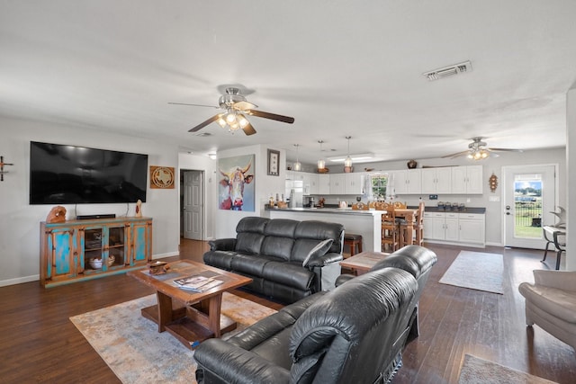 living room with ceiling fan and dark wood-type flooring