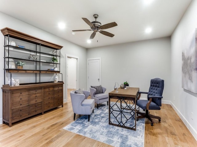 sitting room with ceiling fan and light hardwood / wood-style flooring