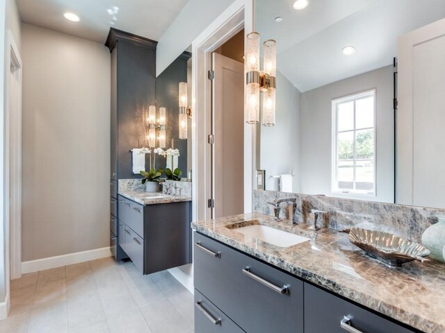 bathroom featuring tile patterned flooring and vanity