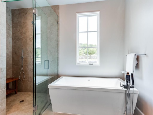 bathroom featuring tile patterned flooring and separate shower and tub