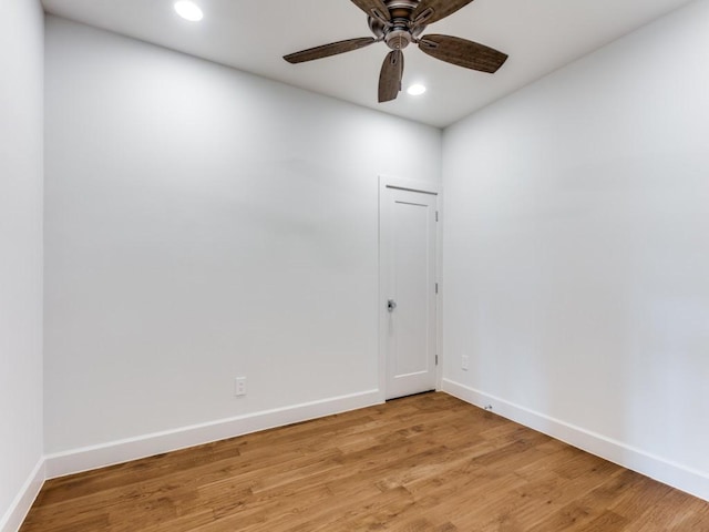 spare room with ceiling fan and light wood-type flooring