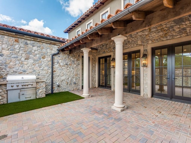 view of patio with area for grilling, grilling area, and french doors