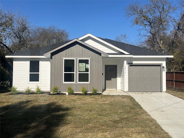 single story home with a garage and a front lawn