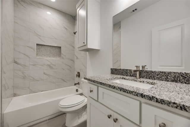 full bathroom with vanity, toilet, and tiled shower / bath