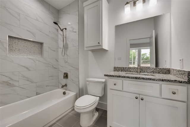 full bathroom with tile patterned floors, vanity, toilet, and tiled shower / bath