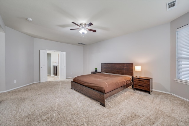 carpeted bedroom with ceiling fan and ensuite bathroom