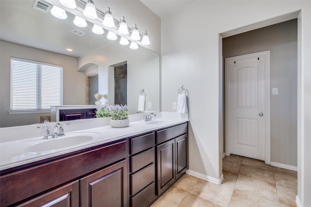 bathroom featuring tile patterned flooring and vanity