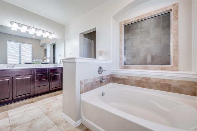 bathroom with a washtub and vanity