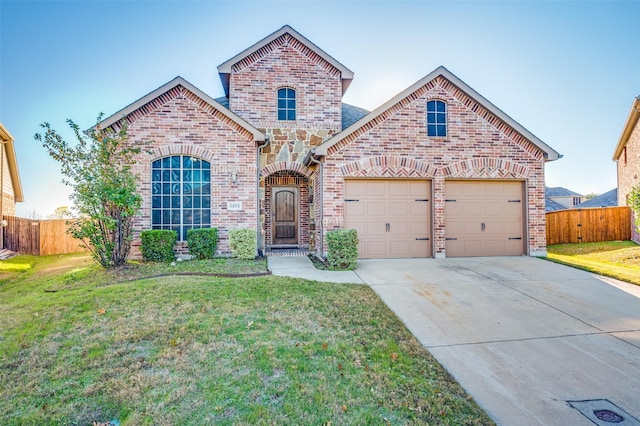 view of property featuring a garage and a front yard