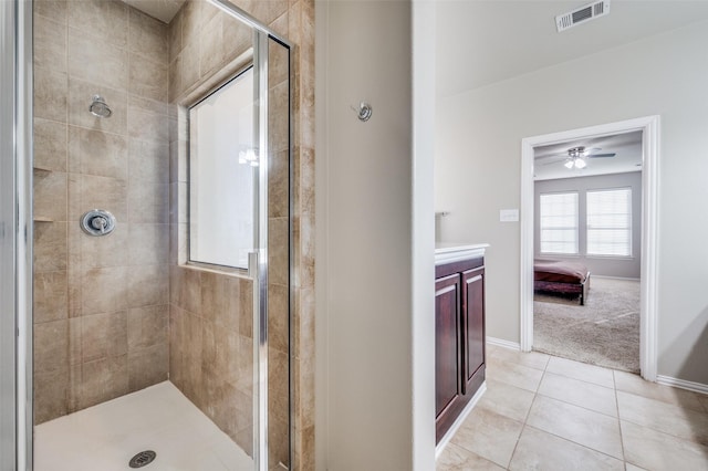 bathroom with vanity, tile patterned floors, and tiled shower