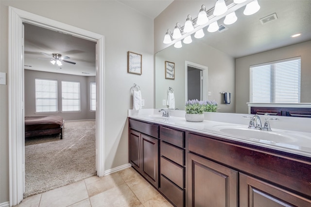 bathroom with tile patterned flooring, vanity, and ceiling fan