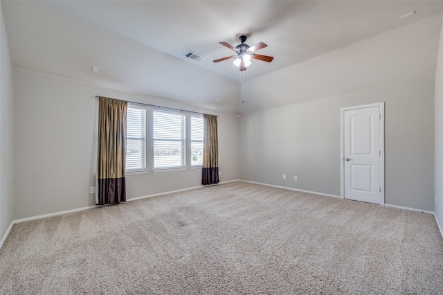 spare room featuring ceiling fan, light colored carpet, and lofted ceiling