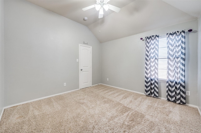 spare room featuring carpet flooring, ceiling fan, and vaulted ceiling