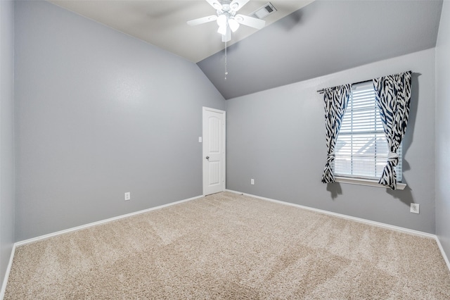 spare room featuring ceiling fan, carpet floors, and vaulted ceiling