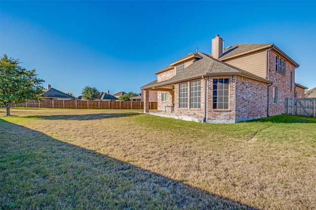 back of property featuring a lawn