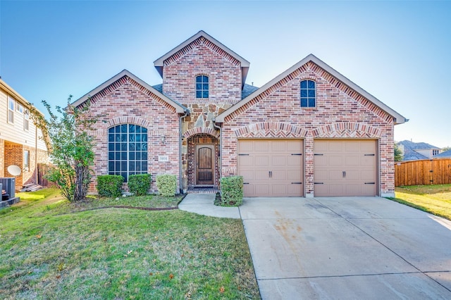 view of property with a garage and a front lawn