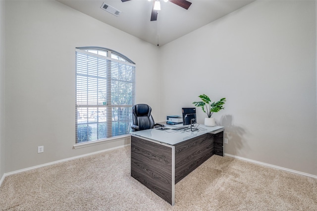 carpeted office space with ceiling fan