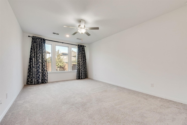 empty room featuring recessed lighting, light carpet, a ceiling fan, visible vents, and baseboards