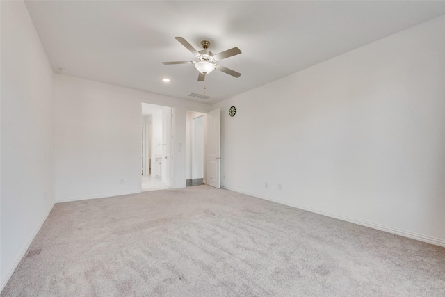 spare room with baseboards, visible vents, a ceiling fan, light colored carpet, and recessed lighting