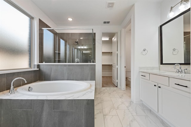 bathroom featuring marble finish floor, visible vents, a garden tub, and a healthy amount of sunlight