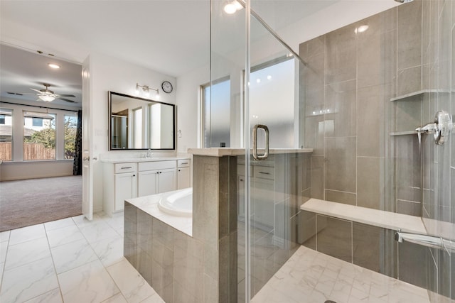 bathroom with a relaxing tiled tub, marble finish floor, ceiling fan, a shower stall, and vanity